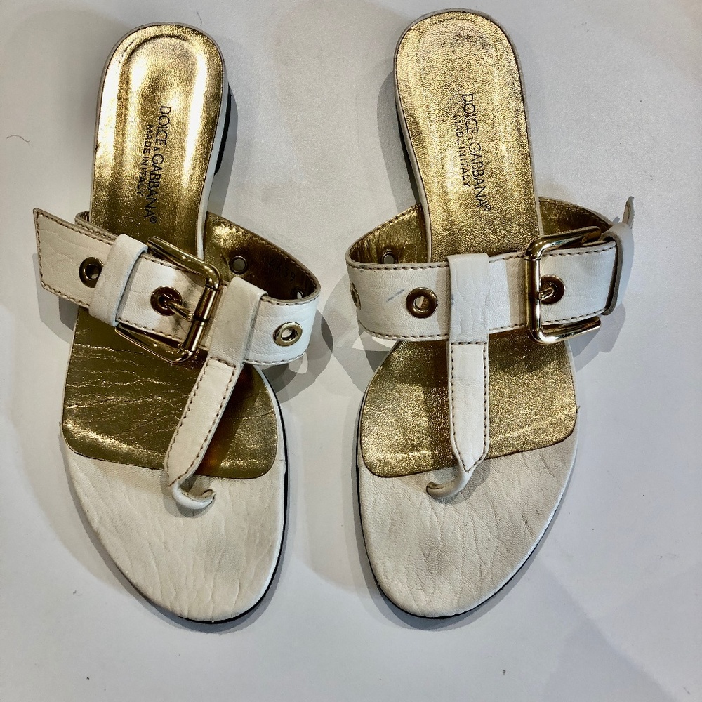 Dolce and Gabbana flat cream sandals with gold buckle accents; 8 1/2